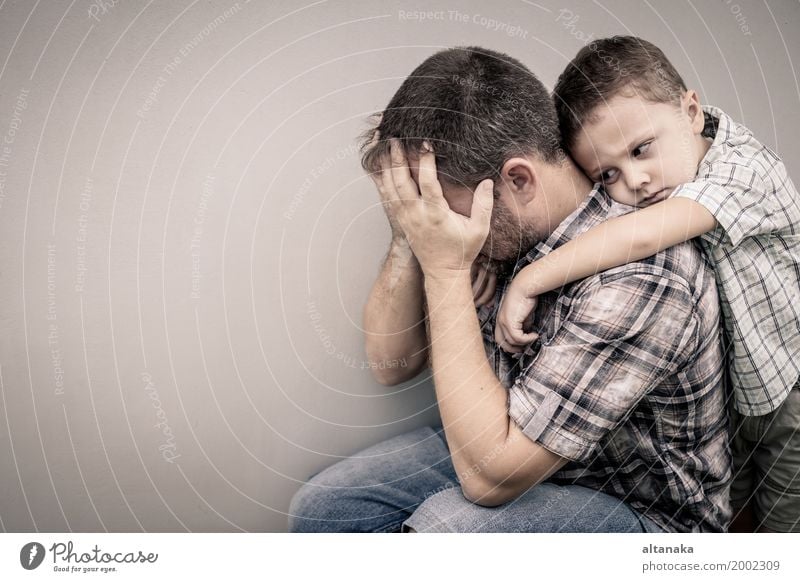 sad son hugging his dad near wall at the day time Face Child Boy (child) Man Adults Parents Father Family & Relations Infancy Sadness Embrace Cry Together