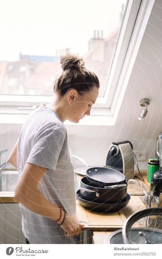 Sad female finished doing the dishes in shiny kitchen room. Lifestyle Living or residing Flat (apartment) House (Residential Structure) Kitchen Woman Adults