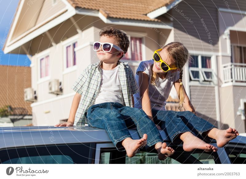 Happy children getting ready for road trip on a sunny day. Concept of friendly family. Lifestyle Joy Leisure and hobbies Playing Vacation & Travel Trip