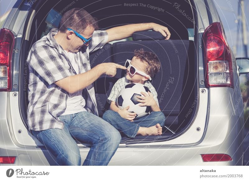 Happy father and son getting ready for road trip on a sunny day. Lifestyle Joy Leisure and hobbies Playing Vacation & Travel Trip Adventure Freedom Summer