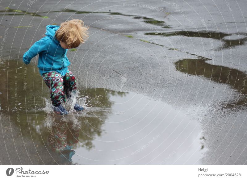 little boy with colorful pants and blue jacket jumps into a puddle Human being Masculine Toddler Infancy 1 1 - 3 years Environment Water Summer Clothing Pants