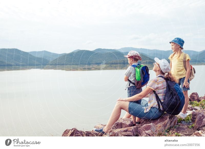 Happy family standing near the lake at the day time. Lifestyle Healthy Vacation & Travel Tourism Trip Freedom Summer Mountain Hiking Looking Sit Colour photo