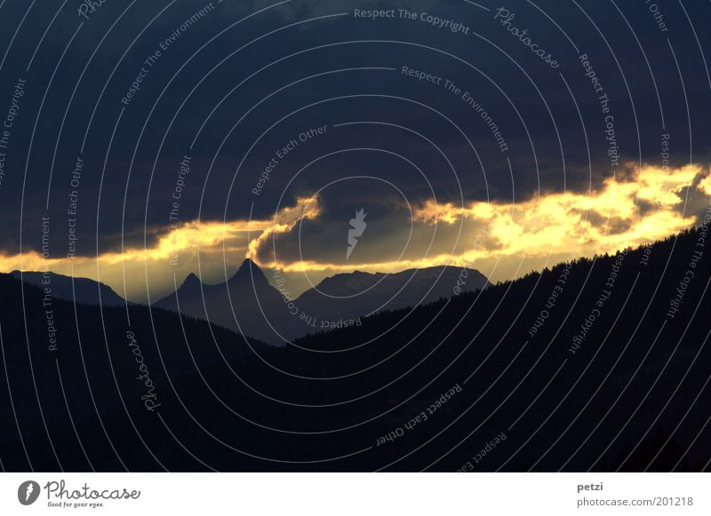 Stripe of light on the horizon Landscape Sky only Clouds Storm clouds Sun Summer Bad weather Alps Mountain Peak Exceptional Threat Dark Fantastic Yellow Black