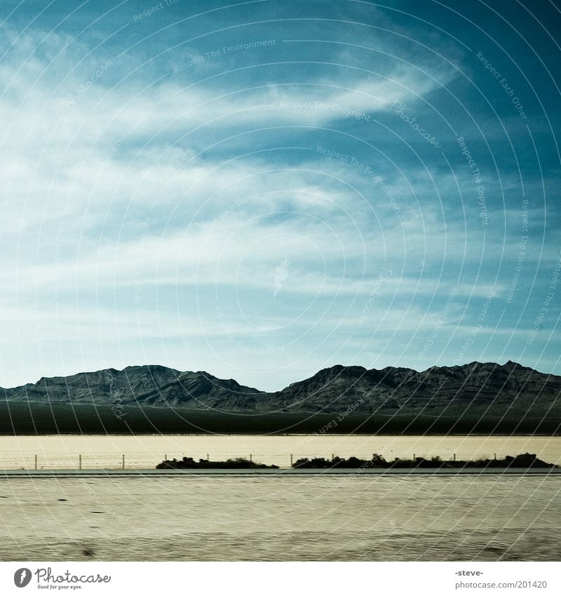 Desert Sky Landscape Clouds Mountain Blue Brown Mojave Nevada Colour photo Exterior shot Copy Space top Day Silhouette Sand Deserted