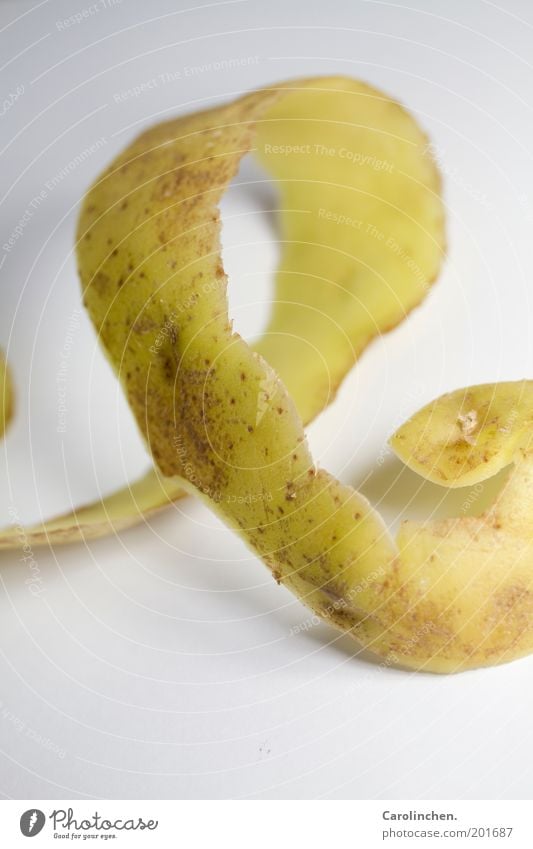 Packaging. Food Vegetable Nutrition Vegetarian diet Long Delicious Potatoes Meandering Thin Brown Yellow White Studio shot Detail Still Life Potato peel