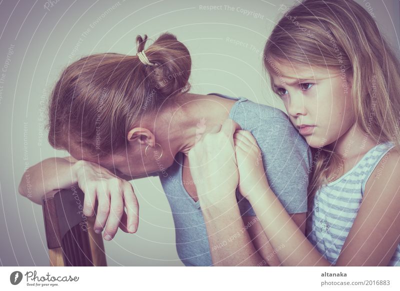 sad daughter hugging his mother at home. Concept of couple family is in sorrow. Lifestyle Face Child Human being Girl Woman Adults Parents Mother