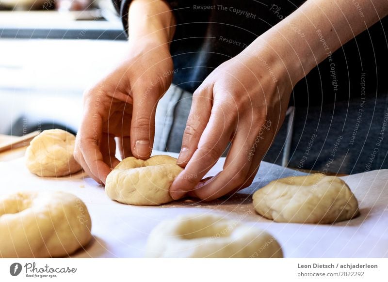 And now with a lot of feeling. Food Dough Baked goods Bagel Authentic Soft Brown Yellow Orange Black White Baking Hand shape Cooking Colour photo Subdued colour