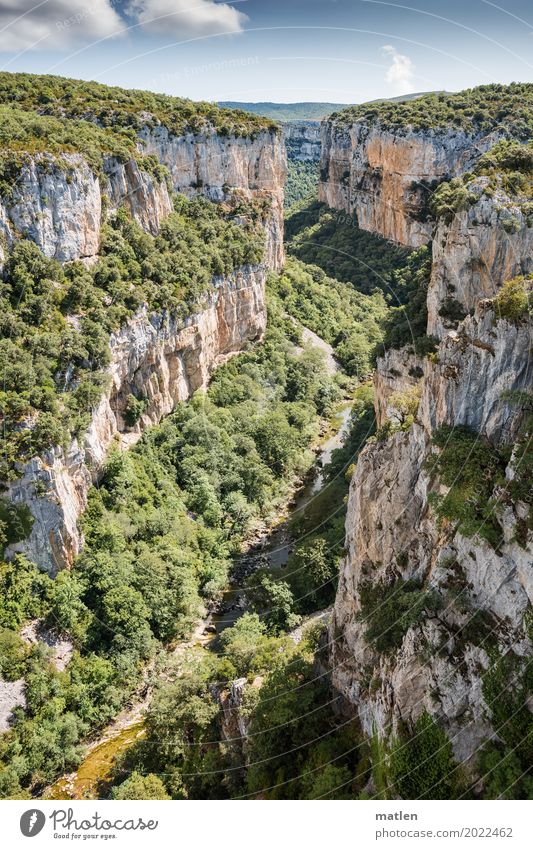 Foz de Arbayún Nature Landscape Plant Sky Clouds Horizon Weather Beautiful weather Tree Grass Rock Mountain Canyon River bank Gigantic Natural Blue Gray Green