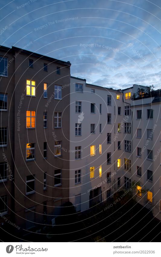 Apartment house in the evening Evening Fire wall Illuminate Facade Window House (Residential Structure) Sky Heaven Blue sky Sky blue Backyard Courtyard Terrace