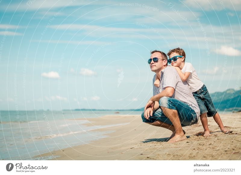 Father and son playing on the beach at the day time. Concept of friendly family. Lifestyle Joy Relaxation Leisure and hobbies Playing Vacation & Travel Trip