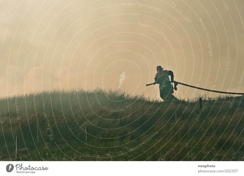 dike fire Fire department Fireman Extinguisher Masculine Man Adults Air Water Sky Ocean North Sea North Sea coast Beach dune Fight Dark Creepy Power