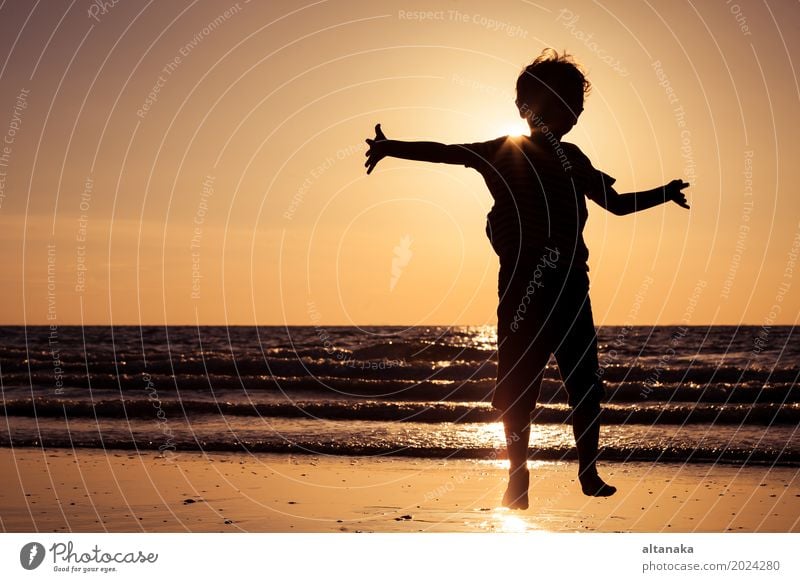 Happy little boy running on the beach Lifestyle Joy Leisure and hobbies Playing Vacation & Travel Trip Adventure Freedom Summer Sun Beach Ocean Sports Child