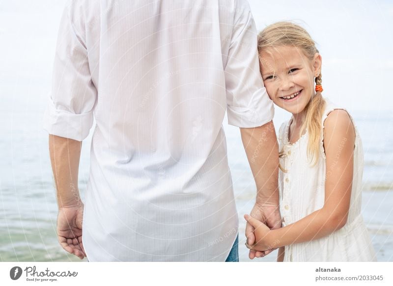 Father and daughter playing on the beach at the day time. Concept of friendly family. Lifestyle Joy Relaxation Leisure and hobbies Playing Vacation & Travel