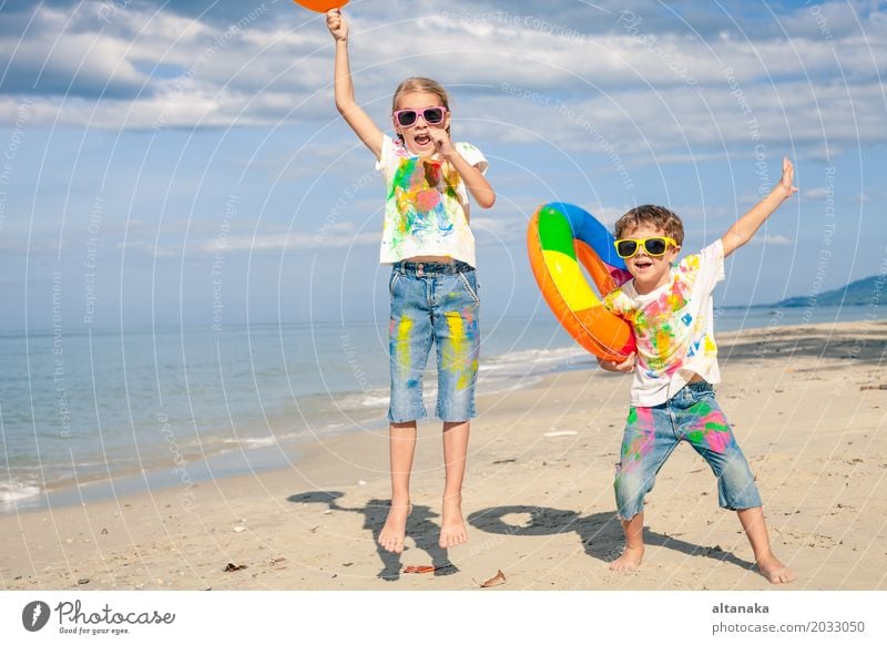 Happy children playing on the beach Lifestyle Joy Beautiful Relaxation Leisure and hobbies Playing Vacation & Travel Adventure Freedom Summer Sun Beach Ocean