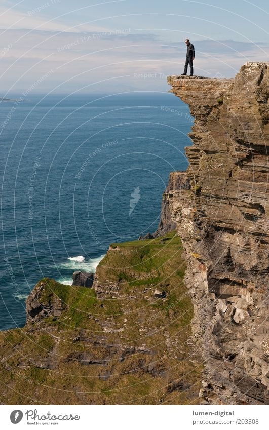 high up Freedom Island Climbing Mountaineering Hiking Man Adults Rock Coast Ocean Tall Vantage point Exposed Steep Brave Height Dangerous Cliff Colour photo