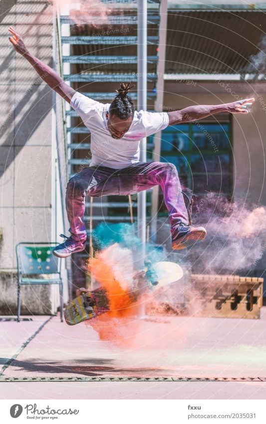 Skating with Holi powder Skateboarding Lifestyle Man Inline skating holi powder Leisure and hobbies Joy Athletic Human being Young man Powder Multicoloured Jump