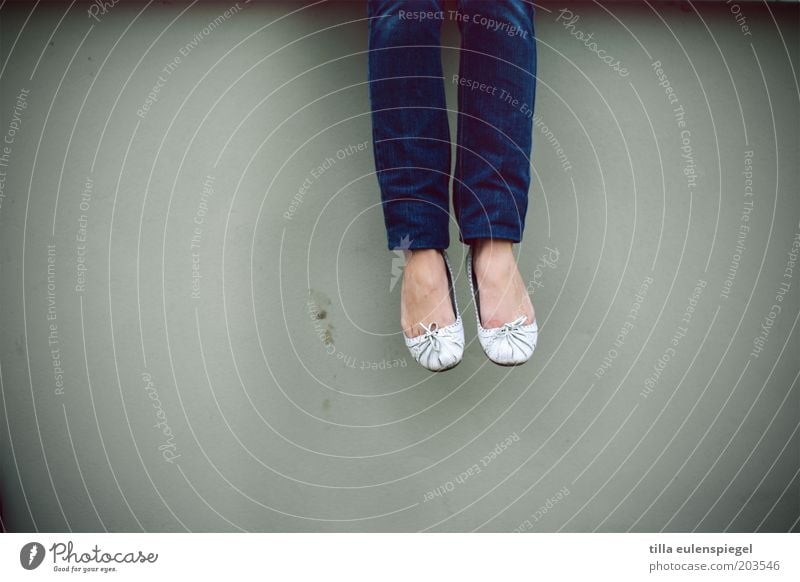 pretty far apart Calm Feminine Young woman Youth (Young adults) Legs Feet 1 Human being Wall (barrier) Wall (building) Jeans Blue Gray Serene Patient Loneliness