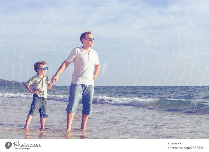 Father and son playing on the beach at the day time. Lifestyle Joy Relaxation Leisure and hobbies Playing Vacation & Travel Trip Adventure Freedom Summer Sun