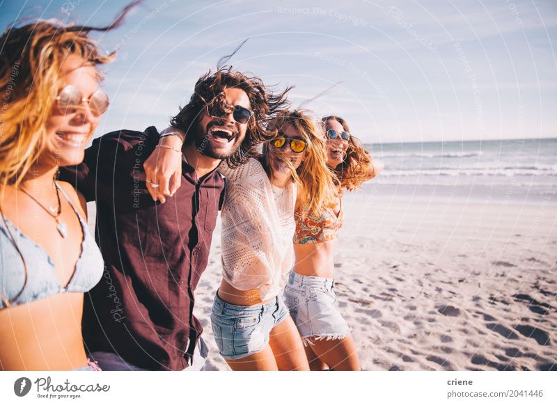 Group of young adult friends walking on the beach together Lifestyle Joy Vacation & Travel Summer Ocean Young woman Youth (Young adults) Young man Friendship