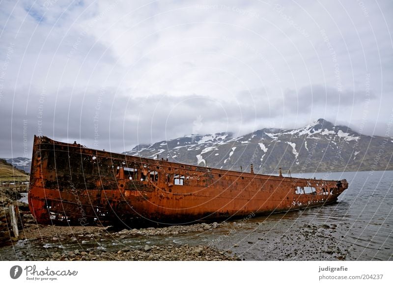 Iceland Environment Nature Landscape Sky Clouds Mountain Snowcapped peak Coast Fjord Ocean Navigation Watercraft Old Threat Dark Creepy Broken Natural Moody