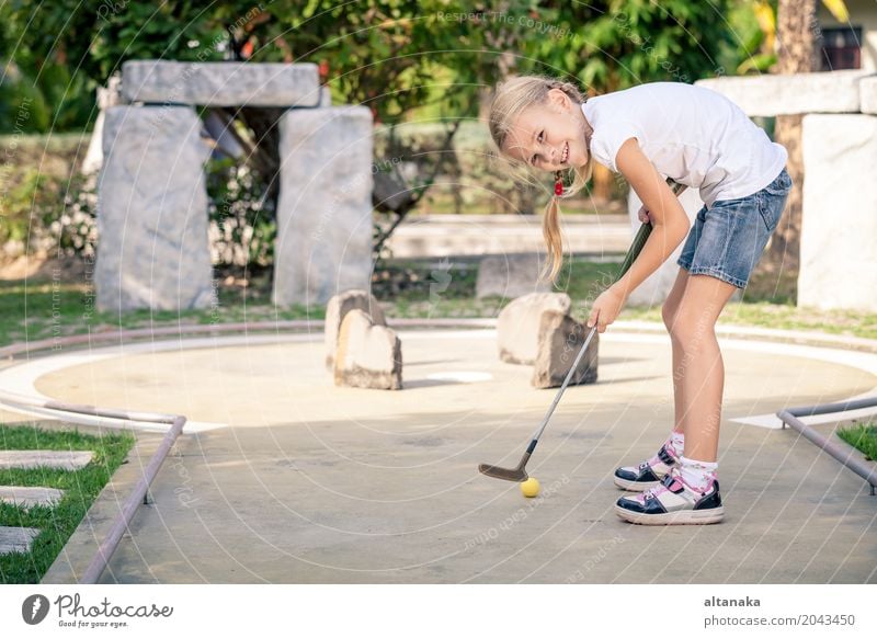 Little girl swinging mini golf club Lifestyle Joy Happy Face Relaxation Leisure and hobbies Playing Vacation & Travel Freedom Summer Club Disco Sports Golf