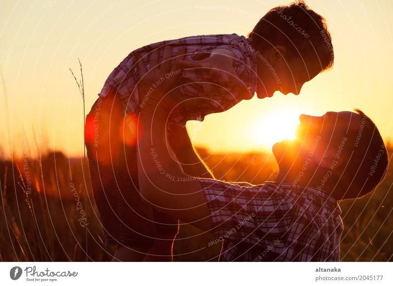 Father and son playing in the park at the sunset time. Lifestyle Joy Happy Leisure and hobbies Vacation & Travel Adventure Freedom Camping Summer Sun Hiking