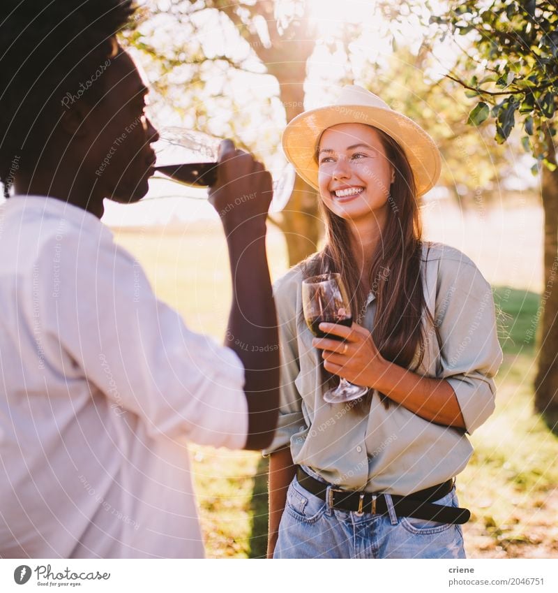 Mixed Race Couple talking to each other and enjoying wine Drinking Lifestyle Joy Happy Leisure and hobbies Summer Sun Going out Young woman Youth (Young adults)