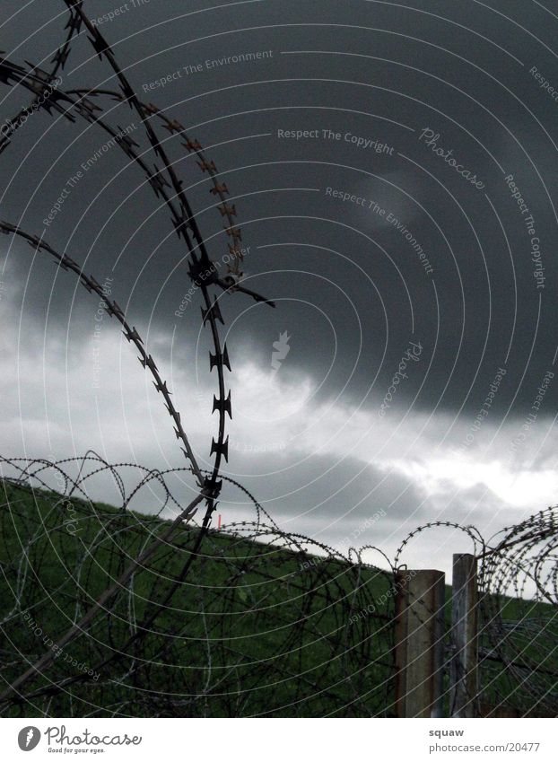 barbed wire Barbed wire Clouds dark sky Landscape