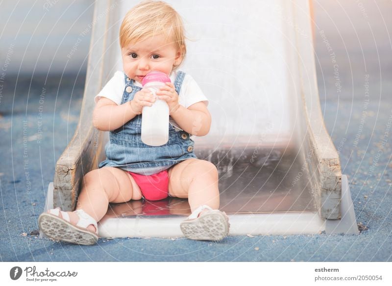 Baby in the playground Food Nutrition Eating Breakfast Lunch Diet Drinking Milk Lifestyle Human being Feminine Infancy 1 0 - 12 months To feed Smiling Cuddly