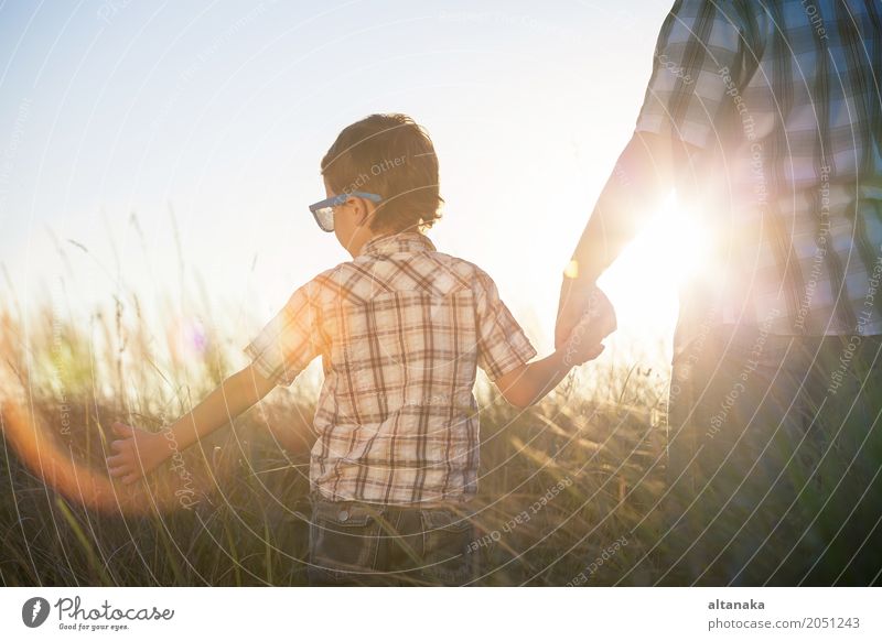 Father and son playing on the field at the day time. People having fun outdoors. Concept of friendly family. Lifestyle Joy Relaxation Leisure and hobbies