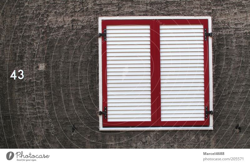 Tight bulkheads Facade Window Sharp-edged Gloomy Gray Red White 43 Disk Exterior shot Close-up Structures and shapes Deserted Day Shutter Digits and numbers