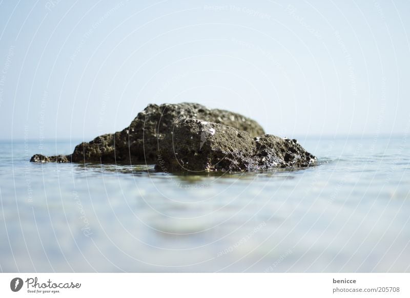 Rock in surf Ocean Water Stone Horizon Blur Miniature Summer Lake Surface of water Day Sky Blue