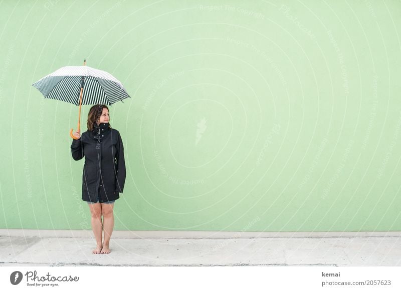 Woman with umbrella in front of green wall Lifestyle Style Harmonious Well-being Contentment Relaxation Calm Leisure and hobbies Vacation & Travel Trip