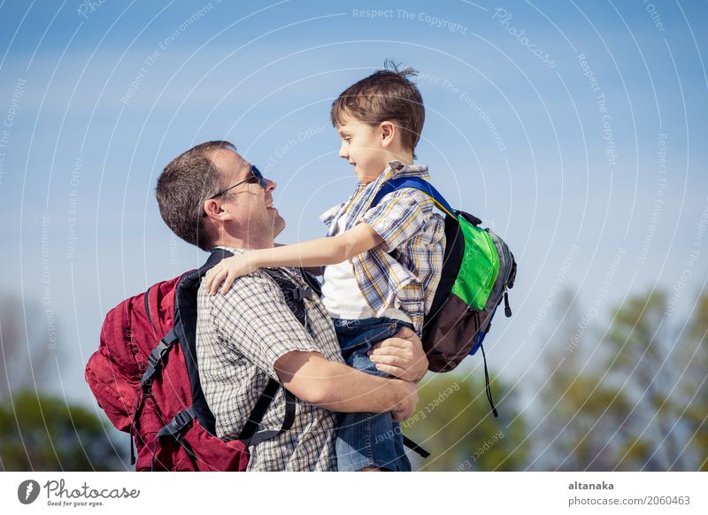 Father and son walking on the road at the day time. Lifestyle Joy Happy Leisure and hobbies Vacation & Travel Tourism Trip Adventure Freedom Camping Summer