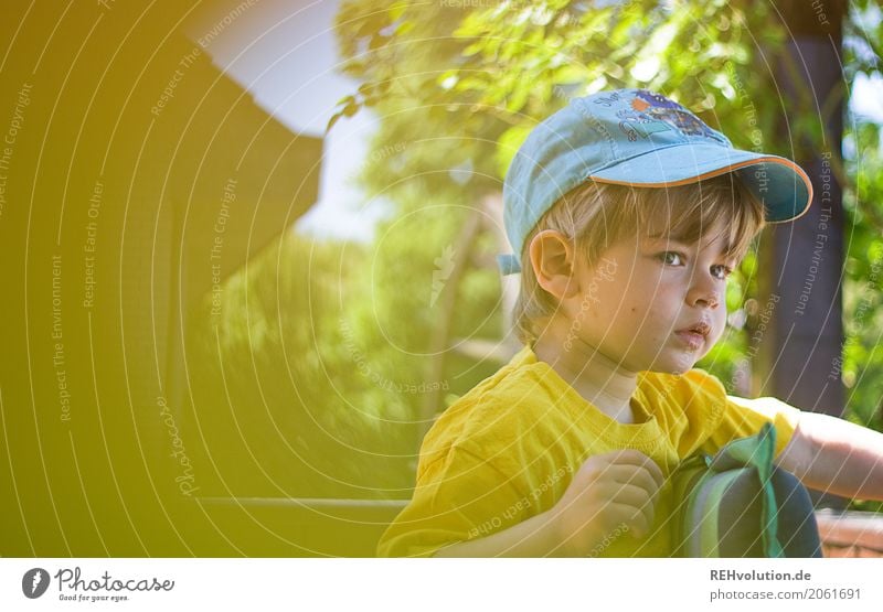 Child in the garden Human being Toddler Boy (child) Face 1 1 - 3 years Nature Summer Garden T-shirt cap Observe Wait Authentic natural Curiosity Yellow Infancy