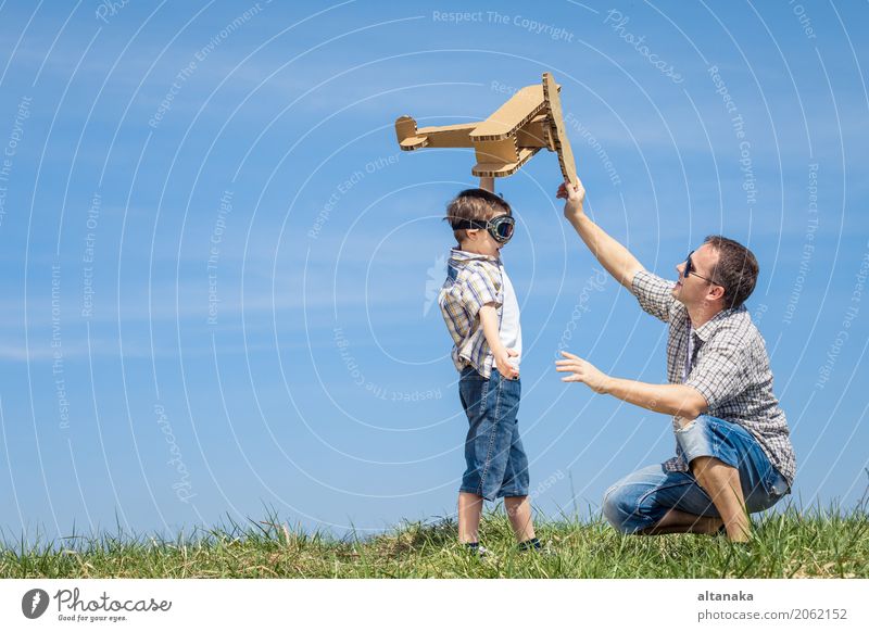 Father and son playing with cardboard toy airplane Lifestyle Joy Happy Leisure and hobbies Playing Vacation & Travel Adventure Freedom Summer Sports Child