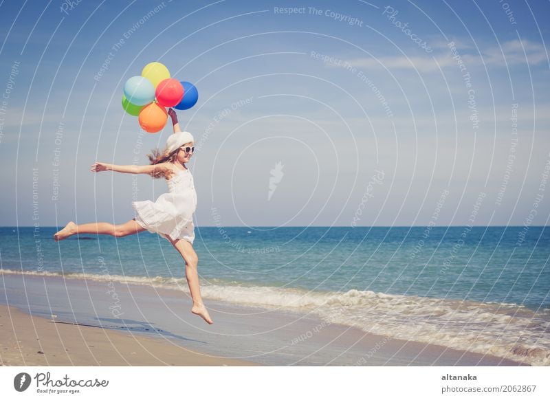 Teen girl with balloons jumping on the beach Lifestyle Joy Happy Relaxation Leisure and hobbies Playing Vacation & Travel Trip Adventure Freedom Summer Sun