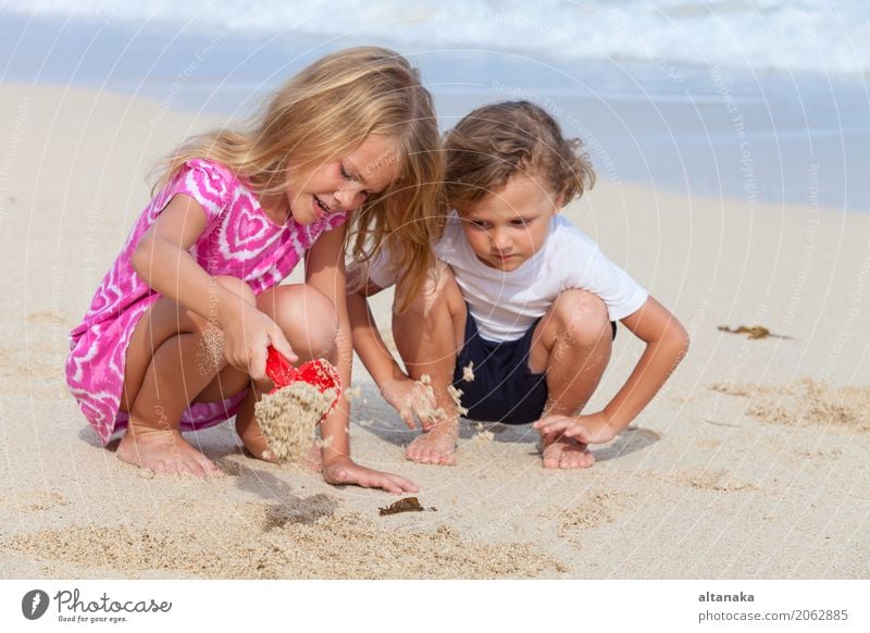 Two happy children playing on the beach Lifestyle Joy Happy Beautiful Relaxation Leisure and hobbies Playing Vacation & Travel Freedom Summer Sun Beach Ocean