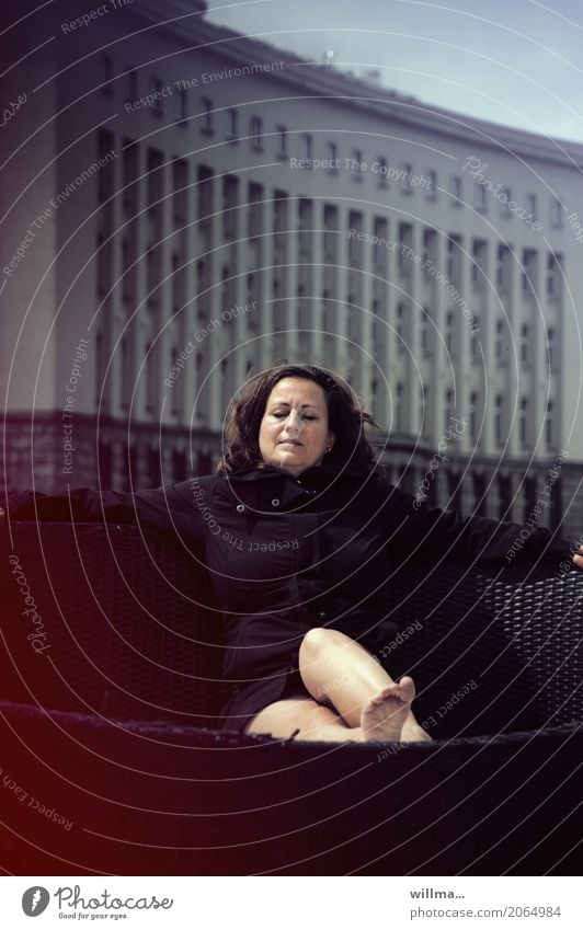 Woman relaxing from stress, in front of an office building Well-being Contentment Relaxation Calm Meditation Deckchair beach chair Beach chair Rattan chair