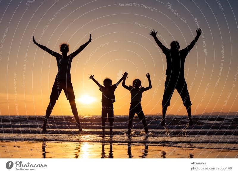 Silhouette of happy family Lifestyle Joy Leisure and hobbies Playing Vacation & Travel Trip Freedom Summer Sun Beach Ocean Sports Child Boy (child) Woman Adults