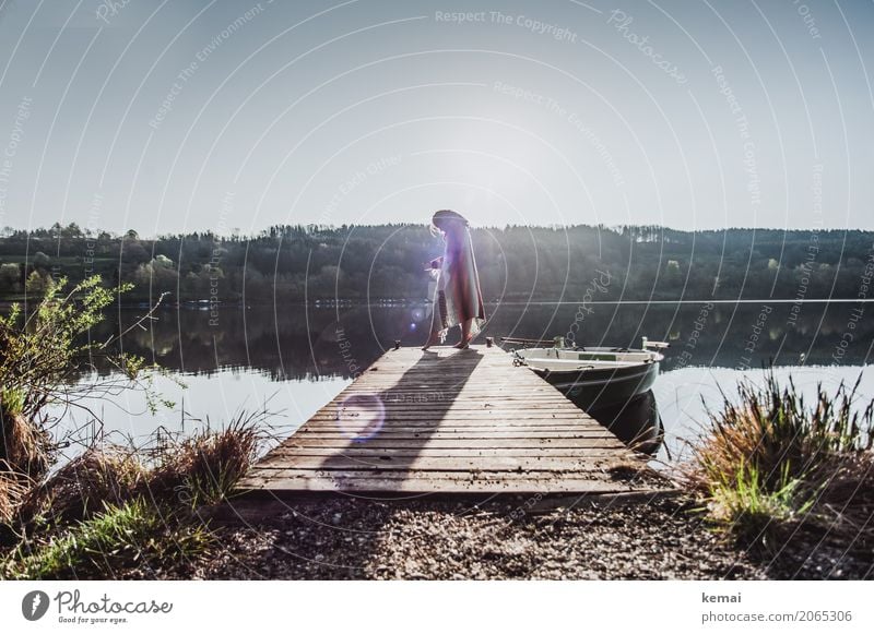 Woman at lake on jetty with blanket around her shoulders Lifestyle Elegant Style Harmonious Well-being Contentment Senses Relaxation Calm Leisure and hobbies