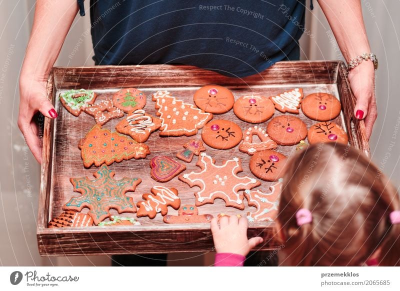 Little girl looking at tray filled with Christmas cookies Decoration Table Kitchen Feasts & Celebrations Child Craft (trade) Human being Woman Adults