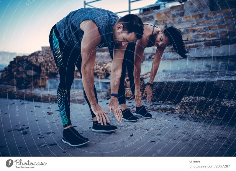 Young athlete couple doing stretching exercise together Lifestyle Joy Happy Wellness Well-being Leisure and hobbies Beach Sports Human being Woman Adults Man