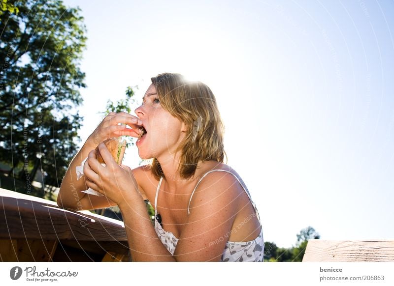 Kebab stuffing Woman Human being Nutrition Eating Fast food Hamburger Cheeseburger Nature Back-light Sit Table Unhealthy Food Roll Sun Summer Park bench Snack