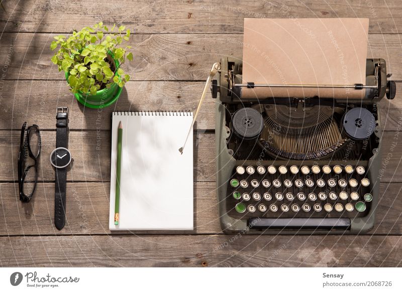 Vintage typewriter on the old wooden desk Coffee Tea Pot Desk Table Workplace Office Newspaper Magazine Book Plant Paper Wood Old Observe Write Retro Green