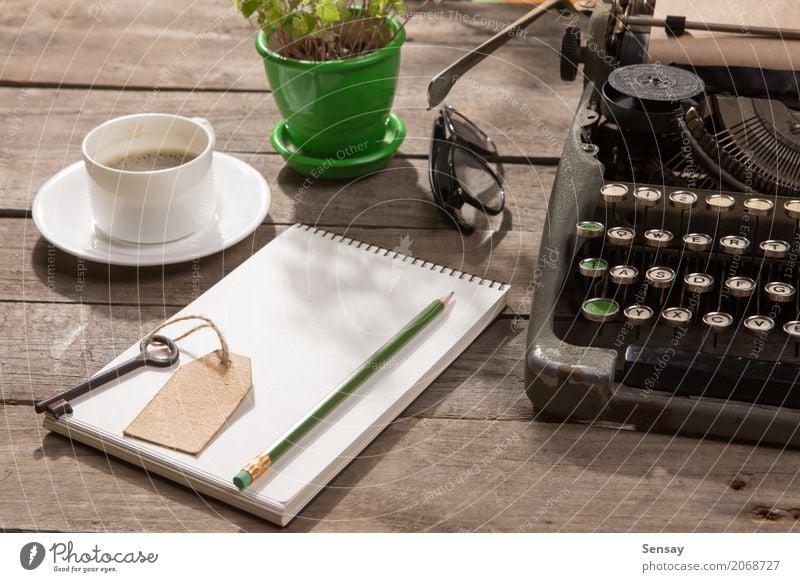 Vintage typewriter on the old wooden desk Coffee Tea Pot Desk Table Workplace Office Newspaper Magazine Book Plant Paper Wood Old Write Retro Green Typewriter