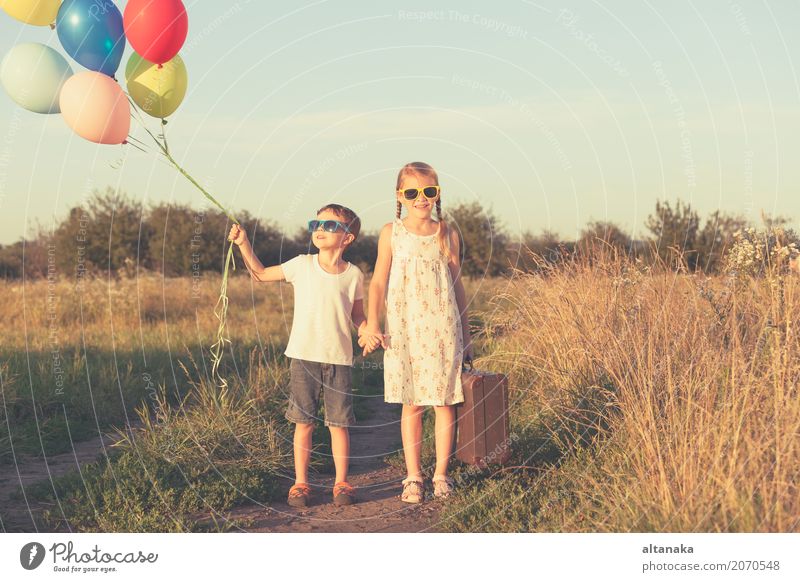 Happy little children playing in the field Lifestyle Joy Leisure and hobbies Playing Vacation & Travel Trip Adventure Freedom Camping Summer Sun Hiking Child