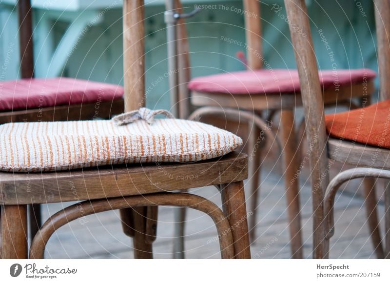 After the orchestra rehearsal Chair Wood Brown Multicoloured Striped Bolster Cloth pattern Colour photo Subdued colour Close-up Detail Deserted