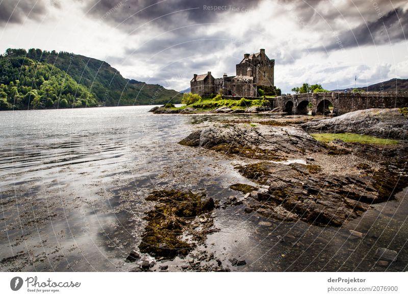 Eilean Donan Castle in Scotland Clouds Ledge coast Lakeside River bank Summer Landscape Rock Bay Plant Fjord Island Europe Exterior shot Subdued colour