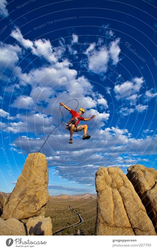 Climber jumping across gap. Adventure Climbing Mountaineering Rope Man Adults 1 Human being 30 - 45 years Nature Peak Helmet Jump Athletic Tall Self-confident